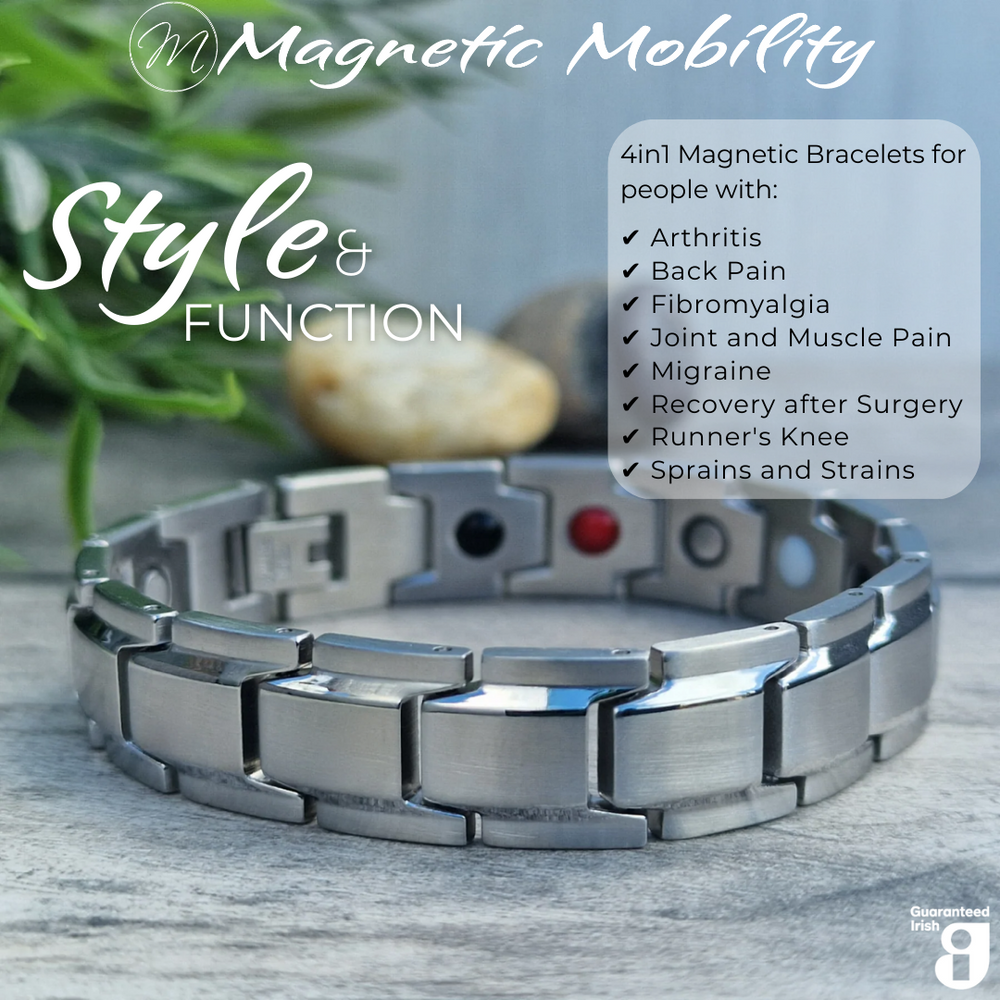 45 degree view of 4in1 magnetic bracelet Alexanders Star by Magnetic Mobility, featuring a sleek sliver design. The bracelet is designed for people with arthritis, back pain, fibromyalgia, joint and muscle pain, menopause symptoms, migraine and more. The bracelet is shown on a wooden surface 