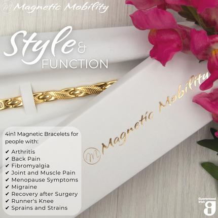 Top view of the Snapdragon Sun 4in1 Magnetic bracelet from Magnetic Mobility on a white gift box. I The bracelet is designed for people with arthritis, back pain, fibromyalgia, joint and muscle pain, menopause symptoms, migraine and more. Pink flowers are shown beside the gift box. 