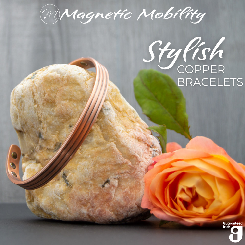 
                  
                    Load image into Gallery viewer, Front view of the Heath Copper bracelet from Magnetic Mobility. The bracelet features a simple design. Featured on a rock with a rose in the foreground signifying its popularity among gardeners for helping with aches and pains. Text states &amp;quot;Stylish Copper Bracelets&amp;quot; and the image features the Guaranteed Irish logo. 
                  
                