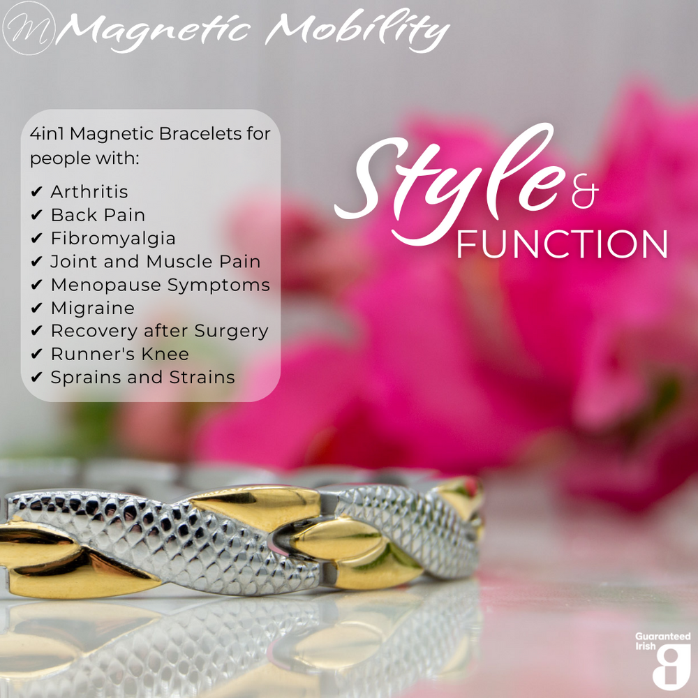 
                  
                    Load image into Gallery viewer, Front view of the Snapdragon Moon 4in1 Magnetic Bracelet, silver and gold coloured bracelet with snakeskin type designs, designed for pain relief, featuring various therapeutic elements. The bracelet is shown on a reflective surface with a pink flower behind it.
                  
                