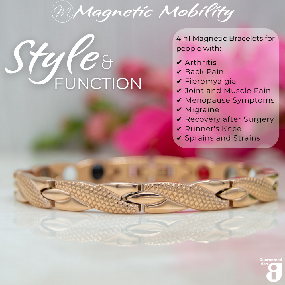 
                  
                    Load image into Gallery viewer, Front view of the Snapdragon Dawn 4in1 Magnetic Bracelet, rose gold coloured bracelet with snakeskin type designs, designed for pain relief, featuring various therapeutic elements. The bracelet is shown on a reflective surface with a pink flower behind it. 
                  
                