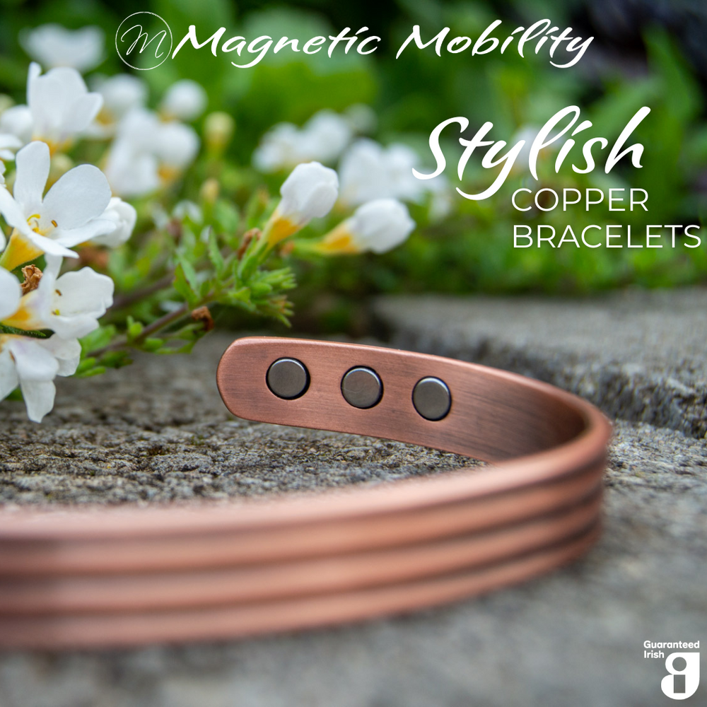 
                  
                    Load image into Gallery viewer, Front view of the heath copper bracelet from Magnetic Mobility. The copper bracelet is featured on a stone surface in a garden signifying its popularity among gardeners for helping combat aches and pains. Text states &amp;quot; Stylish Copper Bracelets&amp;quot; and the image features the Guaranteed Irish Logo. 
                  
                