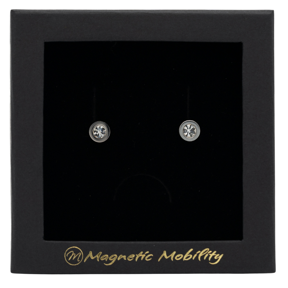 
                  
                    Load image into Gallery viewer, Magnetic Mobility April Birthstone Stud Earrings featuring clear Swarovski crystals, elegantly presented in a black box with Magnetic Mobility branding. These magnetic back earrings offer stylish pain relief.
                  
                