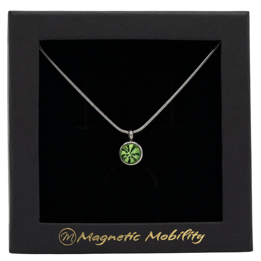 
                  
                    Load image into Gallery viewer, August Magnetic Mobility Birthstone Necklace showcasing a light green Swarovski crystal pendant. Provides relief from neck pain, elegantly presented in branded black packaging.
                  
                