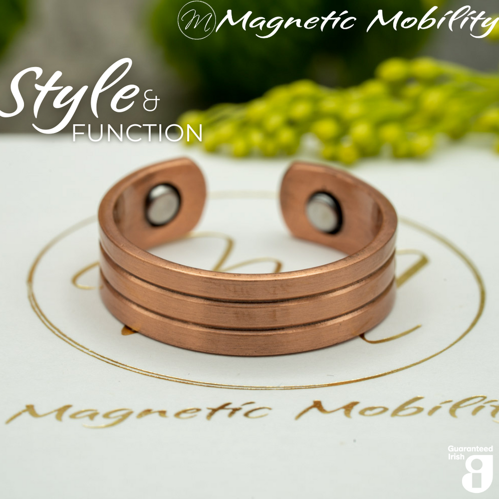 Heath copper ring by Magnetic Mobility featuring a simple design. Ring is shown on top of a white branded gift box. This adjustable ring is designed to be easily worn on arthritic fingers, providing both style and functionality.