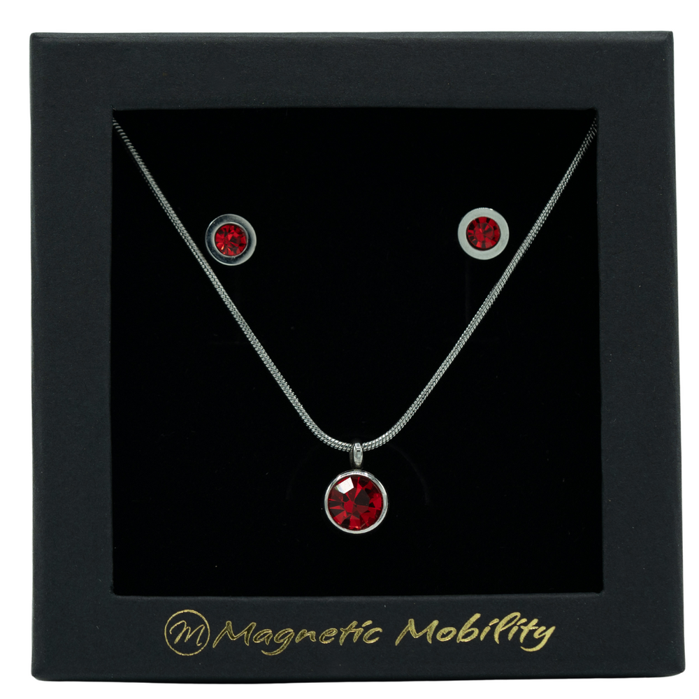 January Magnetic Mobility Birthstone Gift Set featuring a Magnetic Necklace and Stud Earrings featuring January garnet red Swarovski crystals, elegantly presented in a black box with Magnetic Mobility branding. These magnetic back earrings offer stylish pain relief.