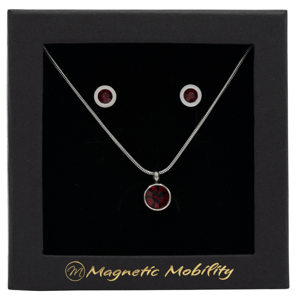 
                  
                    Load image into Gallery viewer, July Magnetic Mobility Birthstone Gift Set featuring a Magnetic Necklace and Stud Earrings featuring ruby red Swarovski crystals, elegantly presented in a black box with Magnetic Mobility branding. These magnetic back earrings offer stylish pain relief.
                  
                