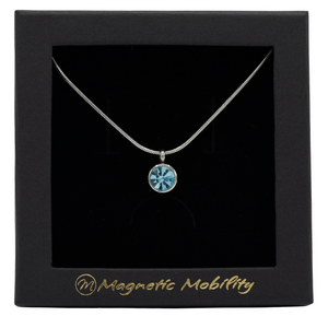 
                  
                    Load image into Gallery viewer, March Birthstone Necklace by Magnetic Mobility featuring a light blue Swarovski crystal pendant with a magnet. Perfect for neck pain relief, displayed in elegant black packaging.
                  
                