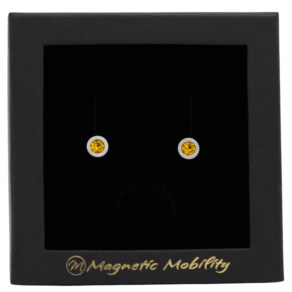 
                  
                    Load image into Gallery viewer, Magnetic Mobility November Birthstone Stud Earrings featuring citrine Swarovski crystals, elegantly presented in a black box with Magnetic Mobility branding. These magnetic back earrings offer stylish pain relief.
                  
                