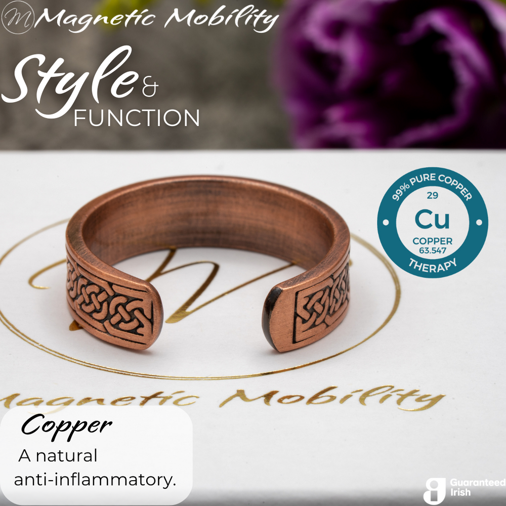 
                  
                    Load image into Gallery viewer, Back view of the Privet copper ring from Magnetic Mobility. Shown on a white gift box with purple plants in the background. The writing says &amp;quot;Style and Function&amp;quot; and shows a Guaranteed Irish logo. The back is open to allow for swelling of arthritic fingers.
                  
                